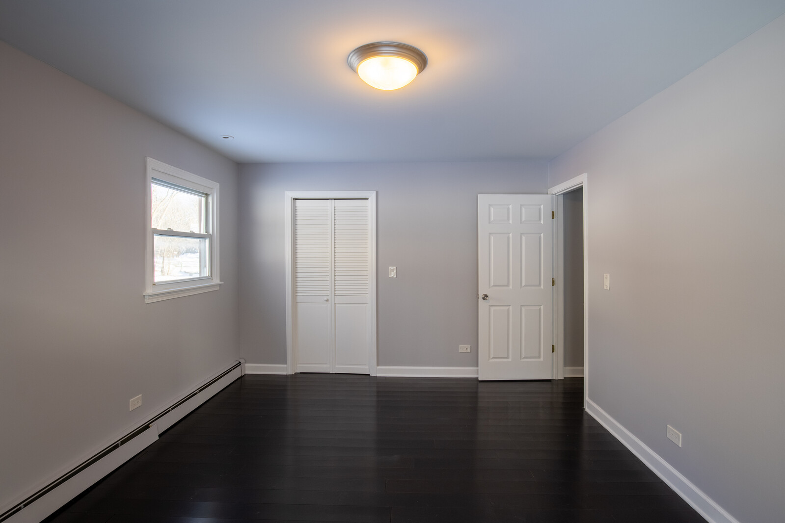 2950 Riverwoods Road Riverwoods, IL 60015 - Photo 17 of 25 an empty room with wooden floor and windows