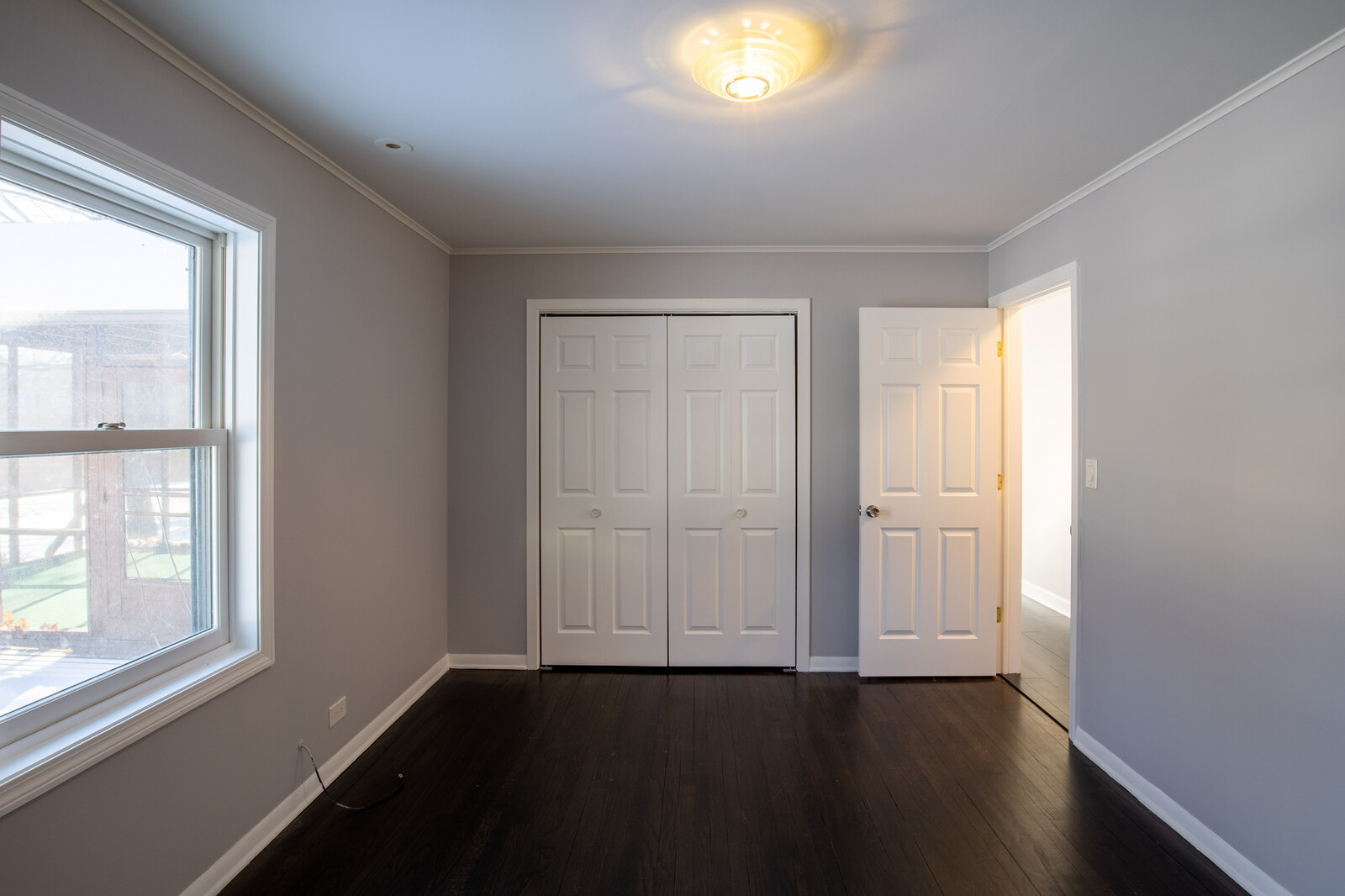 2950 Riverwoods Road Riverwoods, IL 60015 - Photo 20 of 25 an empty room with wooden floor and windows