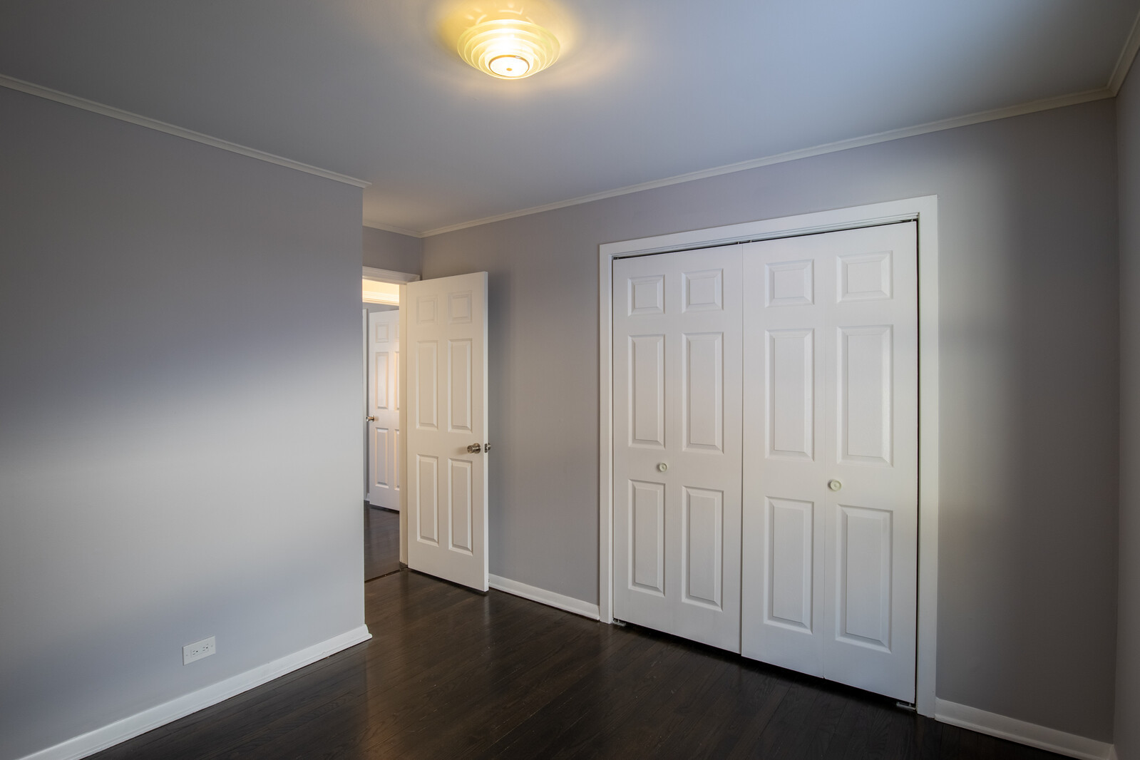 2950 Riverwoods Road Riverwoods, IL 60015 - Photo 23 of 25 an empty room with wooden floor closet and windows