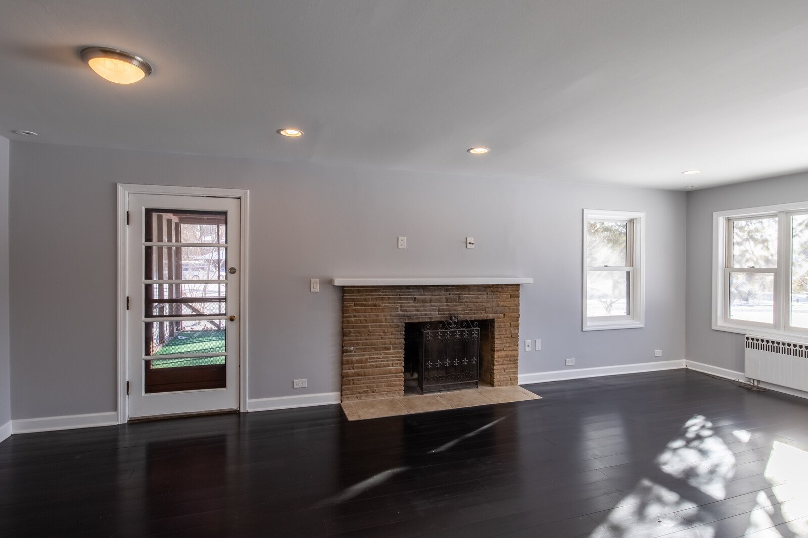 2950 Riverwoods Road Riverwoods, IL 60015 - Photo 4 of 25 a view of an empty room with wooden floor fireplace and a window