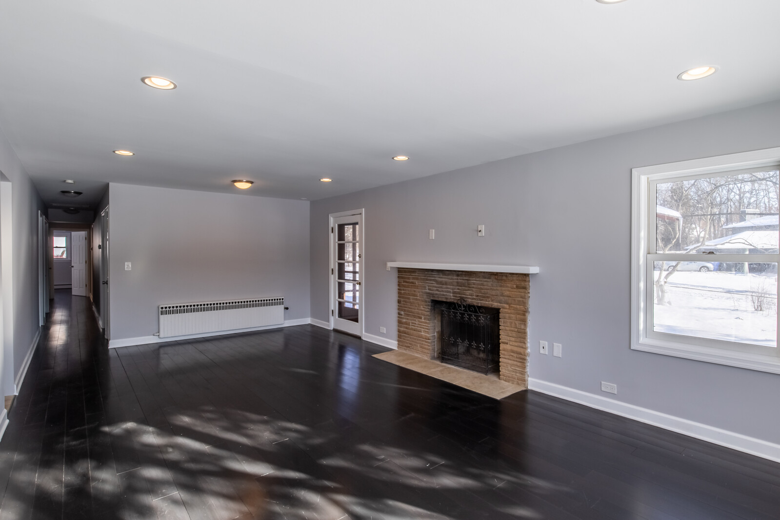2950 Riverwoods Road Riverwoods, IL 60015 - Photo 5 of 25 an empty room with wooden floor fireplace and windows