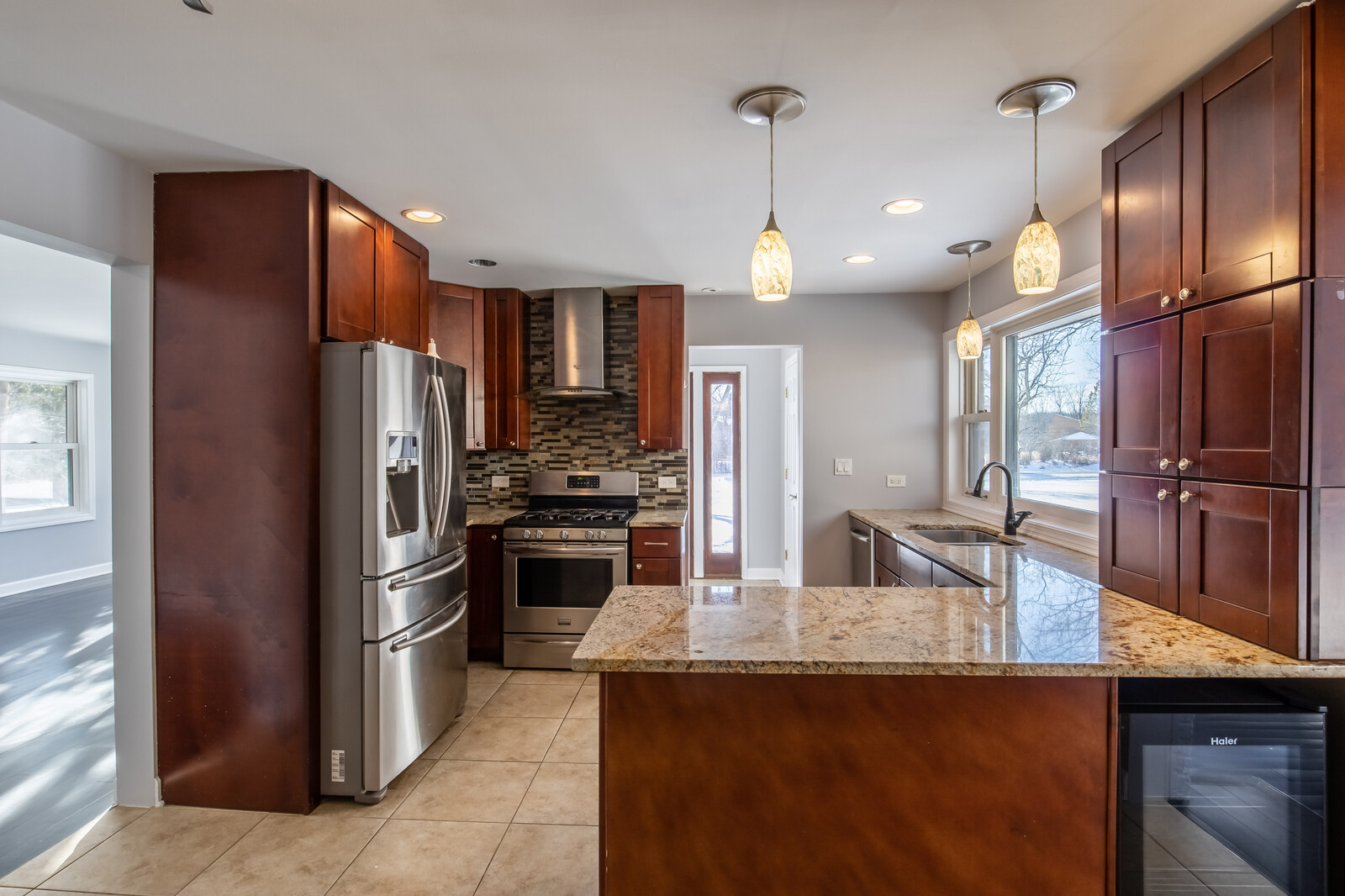 2950 Riverwoods Road Riverwoods, IL 60015 - Photo 9 of 25 a kitchen with stainless steel appliances granite countertop a refrigerator a sink and a stove