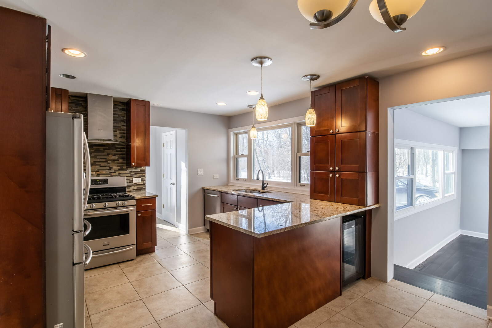 2950 Riverwoods Road Riverwoods, IL 60015 - Photo 10 of 25 a kitchen with stainless steel appliances granite countertop a sink and a refrigerator