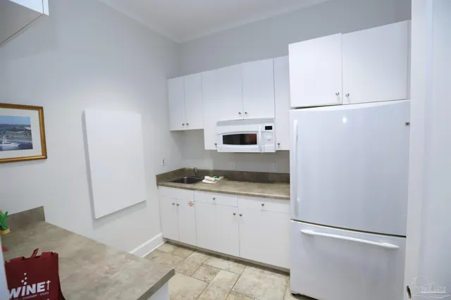 a living room with furniture and floor to ceiling window