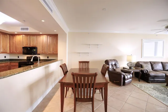 a living room with furniture and a view of kitchen