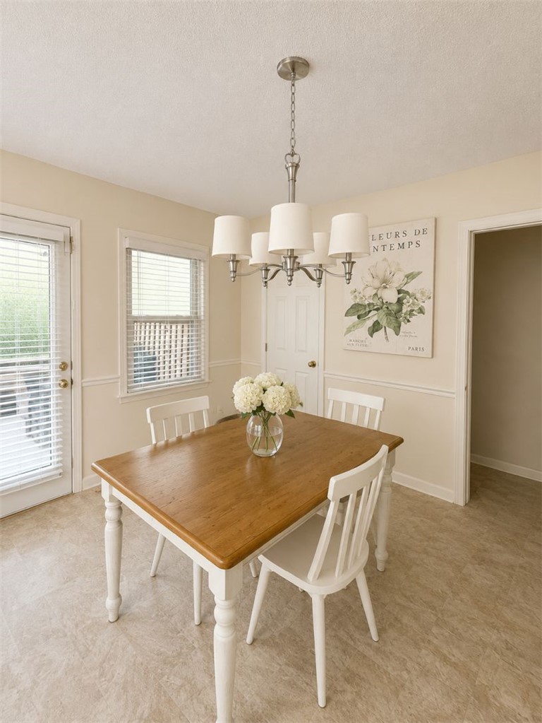 2018 Cardinal Park Drive Anderson, SC 29621 - Photo 3 of 11 A well-lit dining area featuring a classic chandelier and durable vinyl flooring.