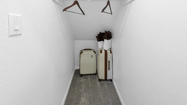 a view of a room with door and wooden floor