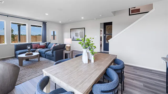a dining room with furniture wooden floor and a potted plant
