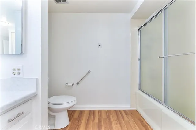 a white toilet sitting next to a bathroom sink