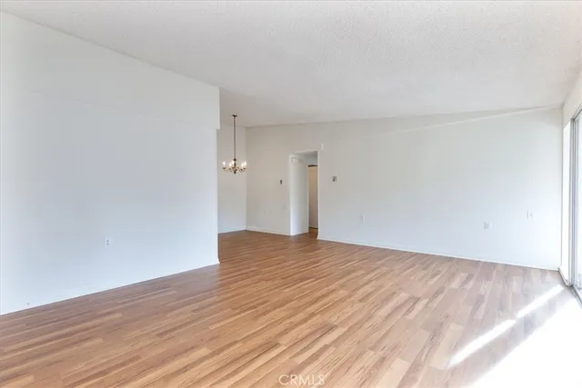 a view of an empty room and wooden floor
