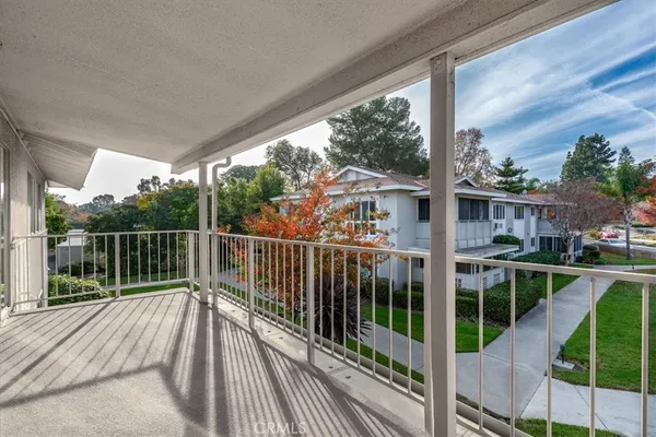 a view of balcony with wooden floor and fence