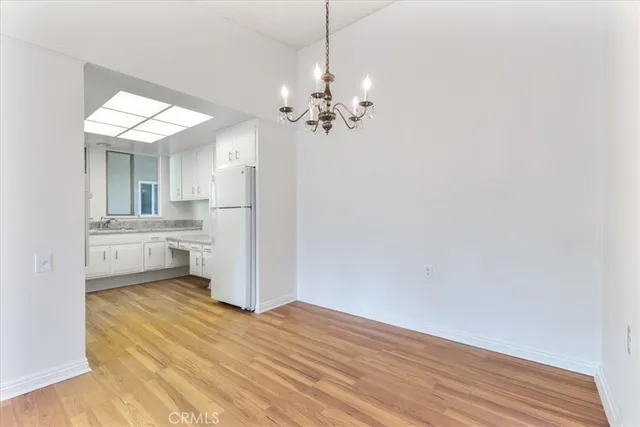 a view of a kitchen with a sink cabinets and wooden floor