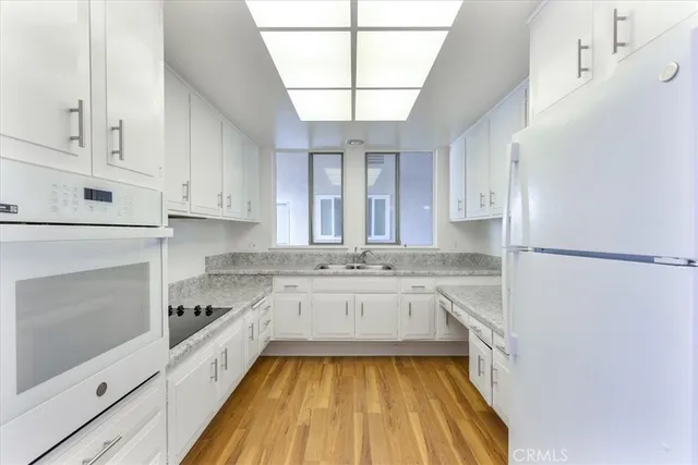 a kitchen with a sink stove and refrigerator
