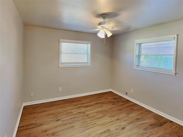 a view of a room with wooden floor and a chandelier