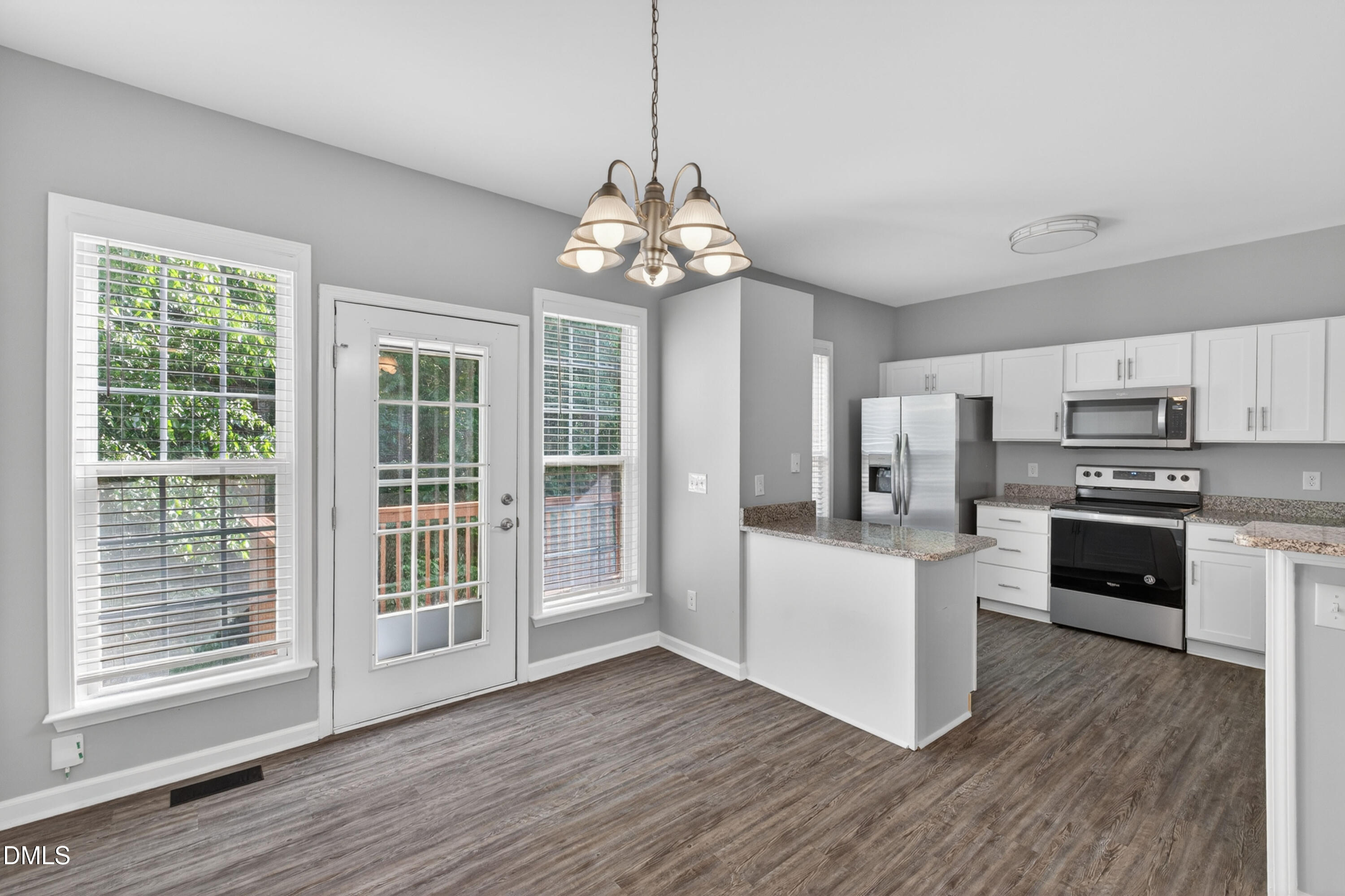 5421 Golden Arrow Lane Raleigh, NC 27613 - Photo 18 of 49 a kitchen with stainless steel appliances granite countertop a refrigerator and a stove top oven