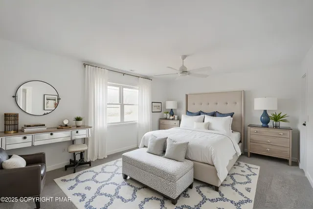 a bedroom with a bed a mirror on dresser and a chandelier