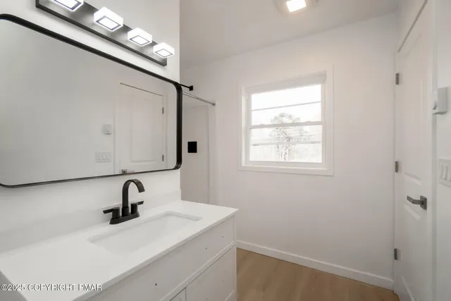 a bathroom with a sink and mirror