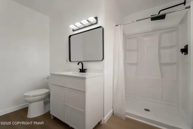 a bathroom with a toilet sink and shower