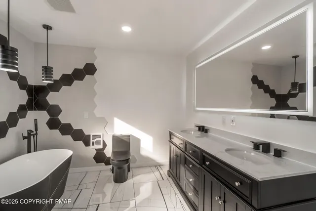 a bathroom with a sink a toilet and a mirror