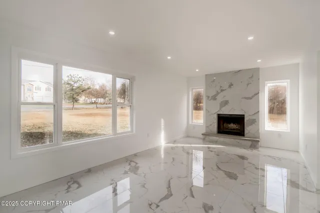 a view of a livingroom with a fireplace and window