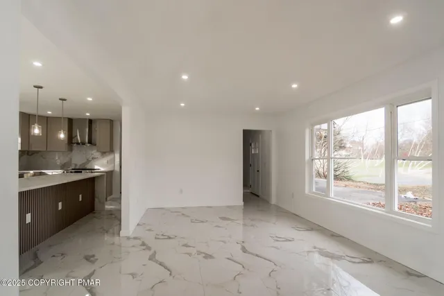 a view of a kitchen with a sink and a large window
