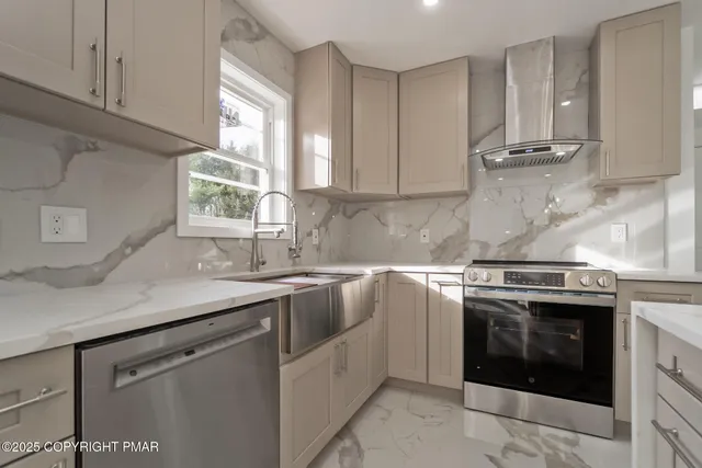 a kitchen with stainless steel appliances granite countertop a sink stove and cabinets