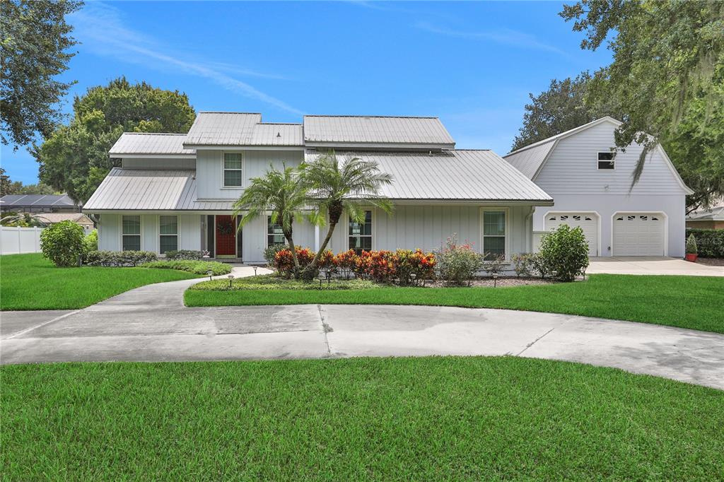 5050 Varty Road Winter Haven, FL 33884 - Photo 1 of 1 a front view of a house with a yard and garage