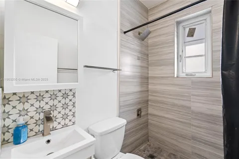 a bathroom with a shower and a toilet
