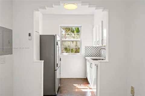 a view of hallway with furniture and a window
