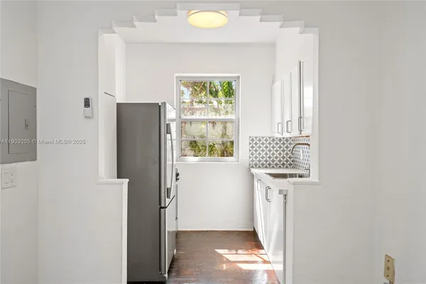 a view of hallway with furniture and a window