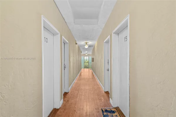 a view of a room with wooden floor and bench