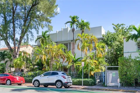 a view of a multi story building with a yard