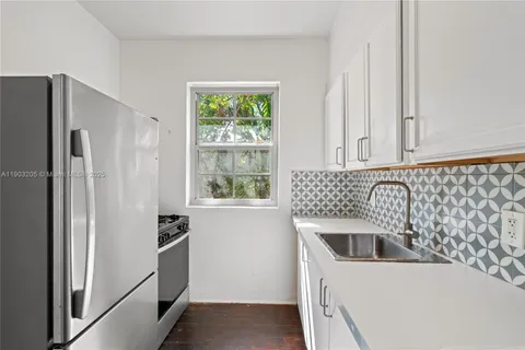 a kitchen with a refrigerator and a sink