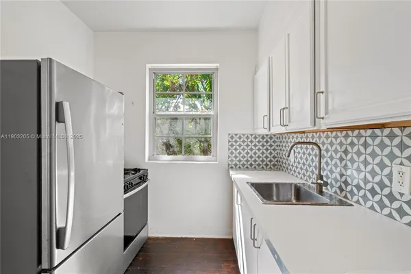 a kitchen with a refrigerator and a sink