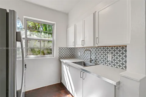 a kitchen with a sink and cabinets