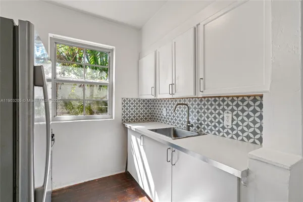 a kitchen with a sink and cabinets