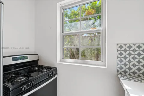 a kitchen with a stove and a window