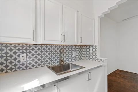a kitchen with a sink and cabinets