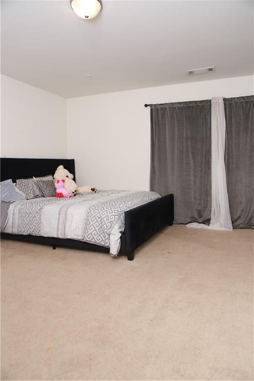 11900 Fuller Street Hampton, GA 30228 - Photo 15 of 17 a bedroom with a bed and a couch