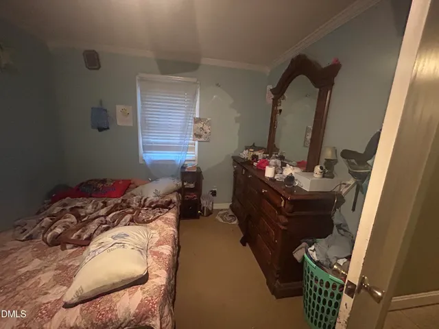 a bedroom with a bed and a mirror