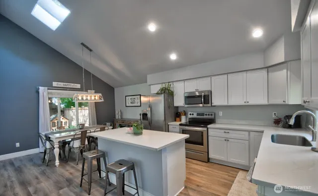 a kitchen that has a lot of cabinets in it and appliances