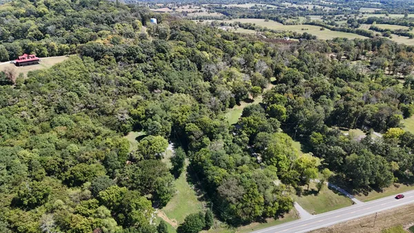 an aerial view of a city with lots of residential buildings and mountain view in back
