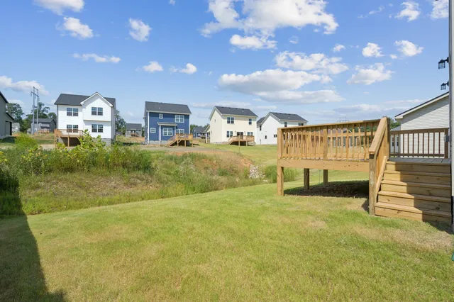 a view of a house with a yard balcony and sitting area
