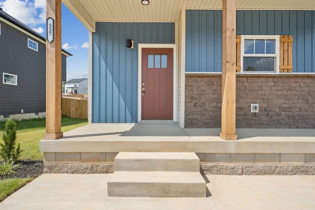 a view of staircase with lots of frames on wall and a window