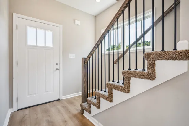a view of an empty room with a window and fireplace