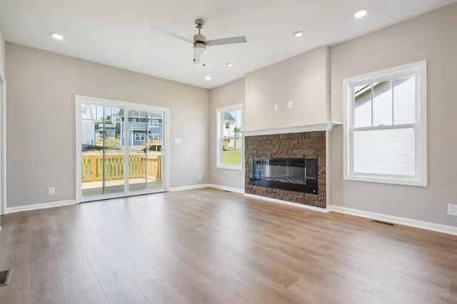 an empty room with wooden floor and chandelier
