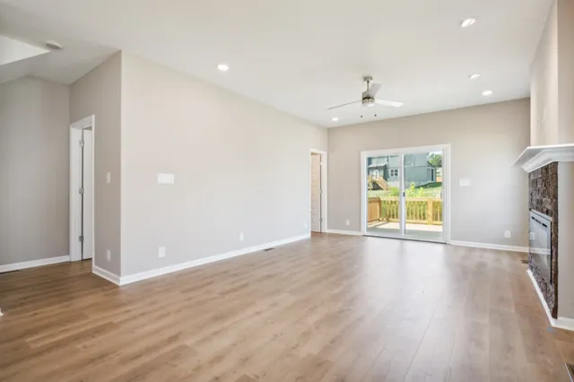 a view of a kitchen with wooden floor and staircase