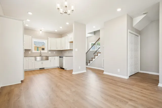 a view of a kitchen with a sink and wooden floor