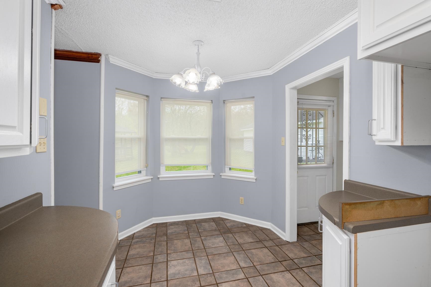 8292 Rankin Branch Road Millington, TN 38053 - Photo 11 of 33 a view of an empty room with window and chandelier