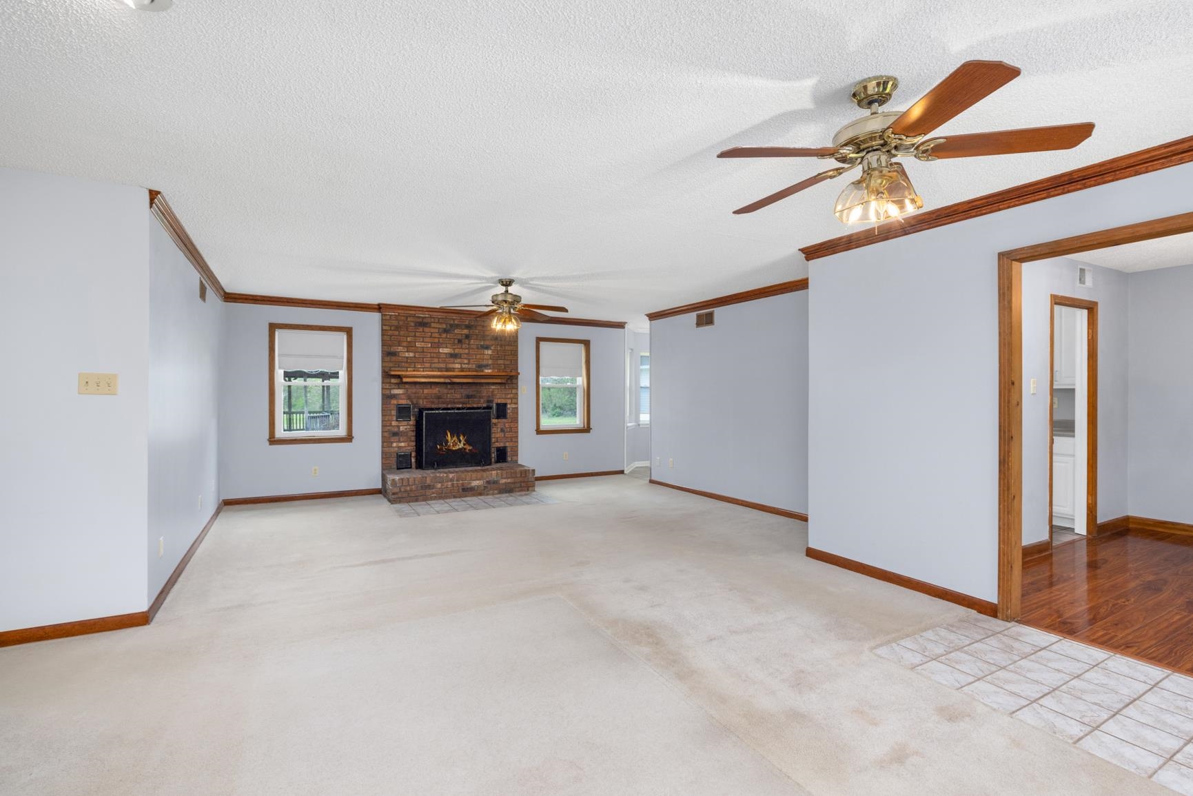 8292 Rankin Branch Road Millington, TN 38053 - Photo 5 of 33 a view of an empty room with a fireplace and a window